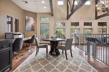 A large room with a table and chairs in the middle at Waters Edge Apartment Homes, Georgetown